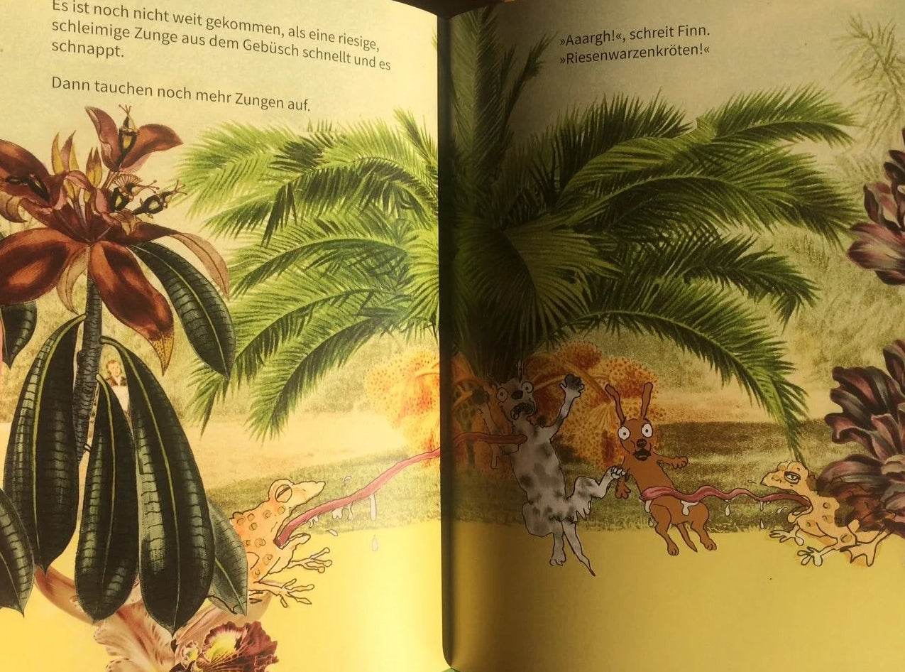 Illustrated book open to a page with animals and plants on a wooden surface