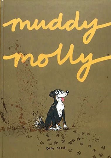 Book titled 'muddy molly' with a dog illustration on a wooden surface